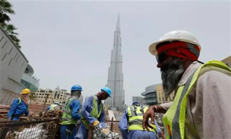 Labourers work near the Burj Khalifa, the tallest tower in the world, in Dubai in this May 9, 2013 file photo. Reuters