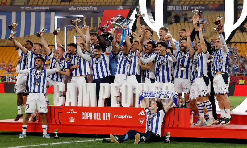 Real Sociedad&rsquo;s Mikel Oyarzabal and teammates celebrate with the trophy after winning the Copa del Rey in Seville, Spain. &ndash; Reuters
