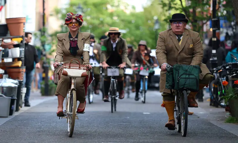 People ride their bicycles during the annual Tweed Run across London, Britain. &ndash; Reuters