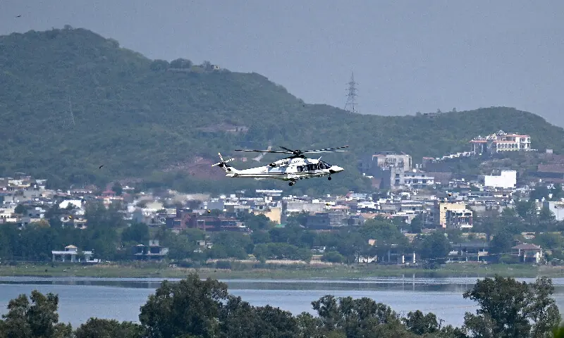 A helicopter flies over the Red Zone area in Islamabad on April 20, 2026, amid heightened security measures ahead of anticipated US-Iran peace talks. AFP