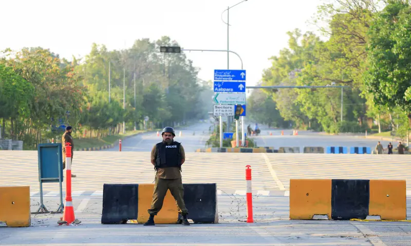Police officers stand guard on a road leading to the Serena Hotel as Pakistan prepares to host the US and Iran for the second phase of peace talks in Islamabad on Tuesday. &ndash; Reuters
