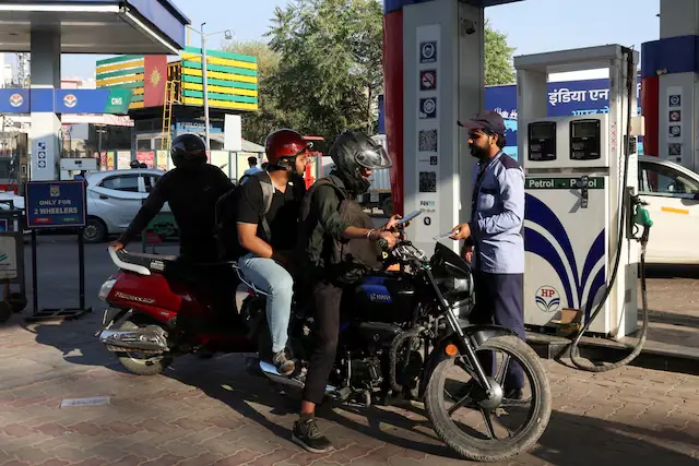 A man refuelling his bike at a fuel station in New Delhi, India. &ndash; Reuters