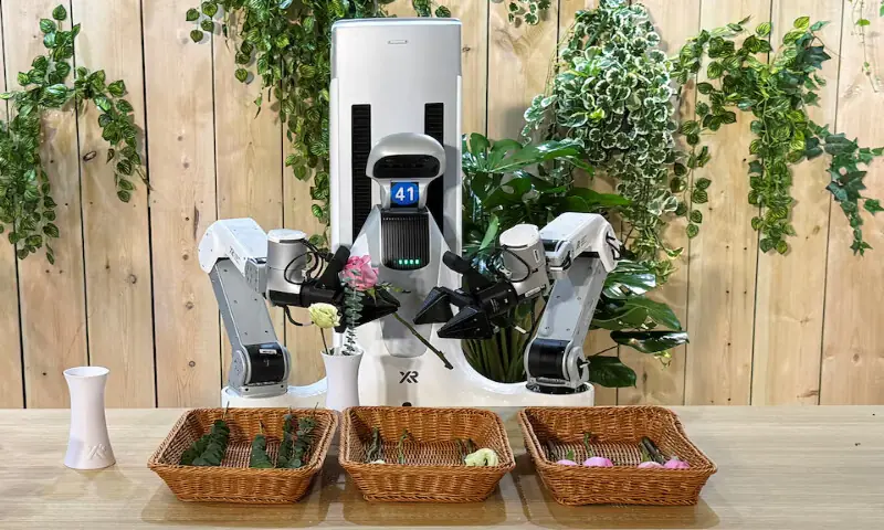 A robot arranges flowers into a vase during a launch event in Beijing, China. &ndash; Reuters