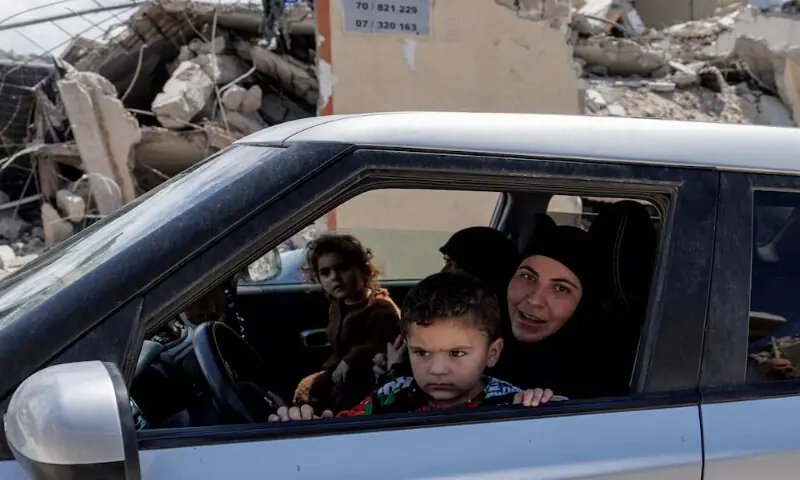 A family drives past shops and houses damaged by an Israeli strike, amid a 10-day ceasefire between Lebanon and Israel, in Mansouri village, southern Lebanon, on April 21, 2026. Reuters