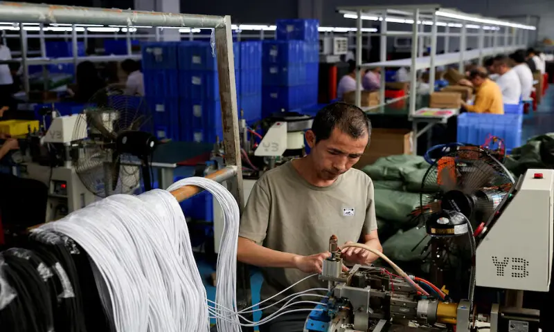 An employee works on USB cables production at a plastic accessories factory, as rising oil prices drive up production costs for plastic manufacturers, in Dongguan, Guangdong province, China, on April 2, 2026. Reuters file