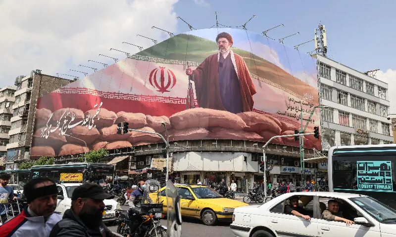 Commuters drive past a large billboard depicting Iran's Supreme Leader Ayatollah Mojtaba Khamenei on a street in Tehran on April 20, 2026. AFP