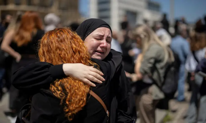 Women react as they hug each other while protesters, including members of the media, attend a vigil to condemn the killing of journalists, a day after journalist Amal Khalil was killed in an Israeli strike, in Martyrs' Square, Beirut, Lebanon. -- Reuters