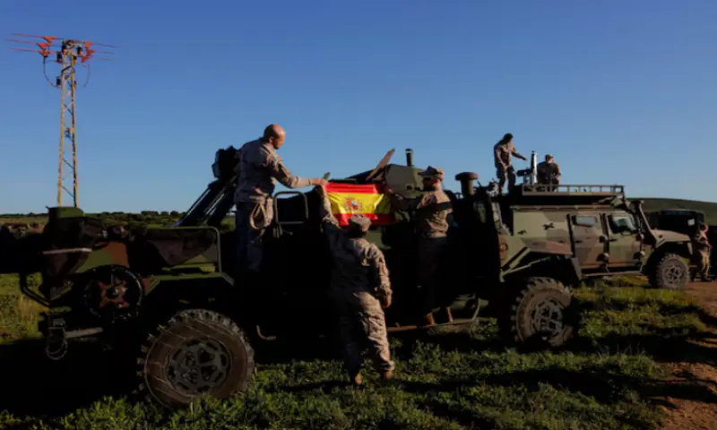 Spanish soldiers place a Spanish flag on a vehicle during Exercise Dynamic Mariner 25 military drill training, which involves naval forces from several NATO members, at Retin beach, in the Atlantic Ocean, in Barbate, Spain. -- Reuters