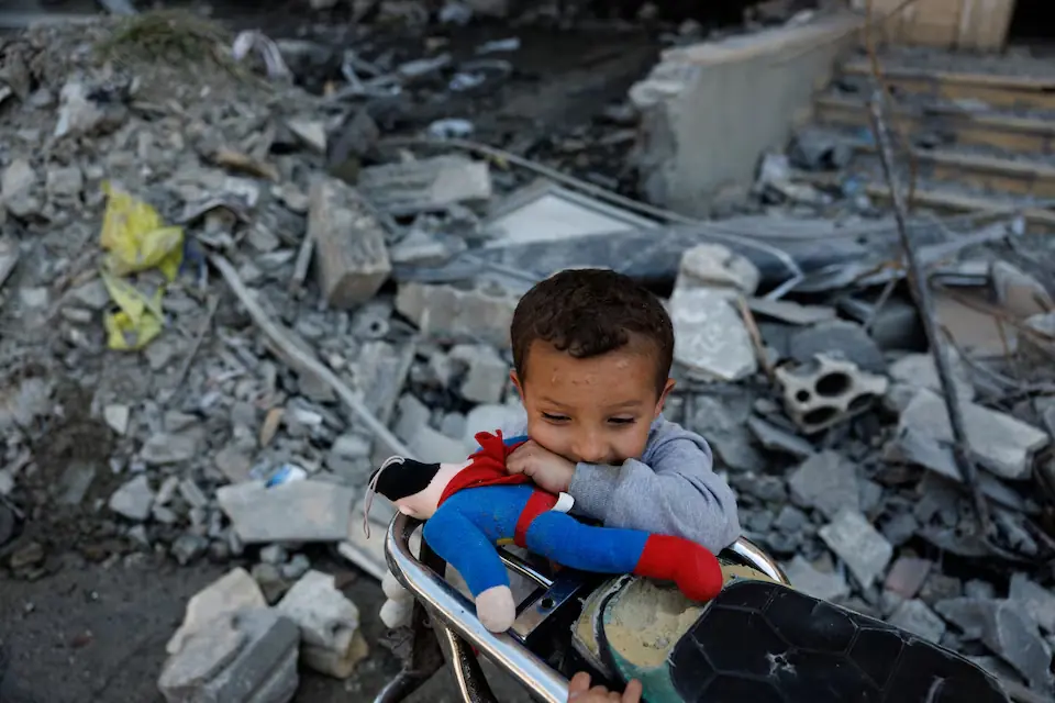 A child plays among the rubble of a building damaged by an Israeli strike, amid a temporary ceasefire between Lebanon and Israel, in Housh near Tyre, Lebanon. -- Reuters