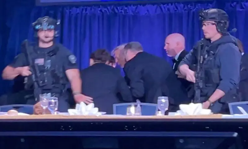 President Trump is escorted out of the dinner. -- Reuters