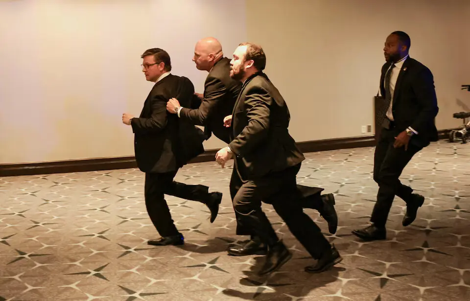 Security officials evacuate US House Speaker Mike Johnson as a shooter opens fire during the annual White House Correspondents' Association dinner in Washington, DC. -- Reuters