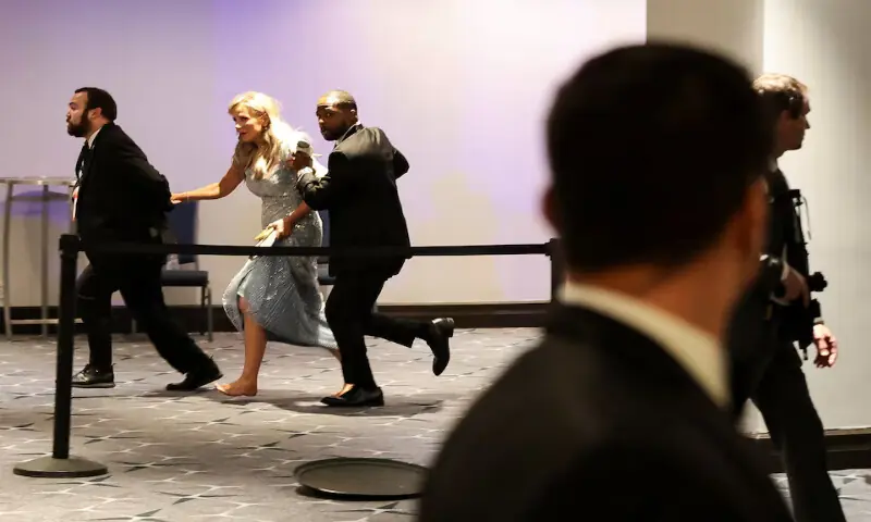 Security officials evacuate a guest as a shooter opens fire during the annual White House Correspondents' Association dinner in Washington, DC. -- Reuters