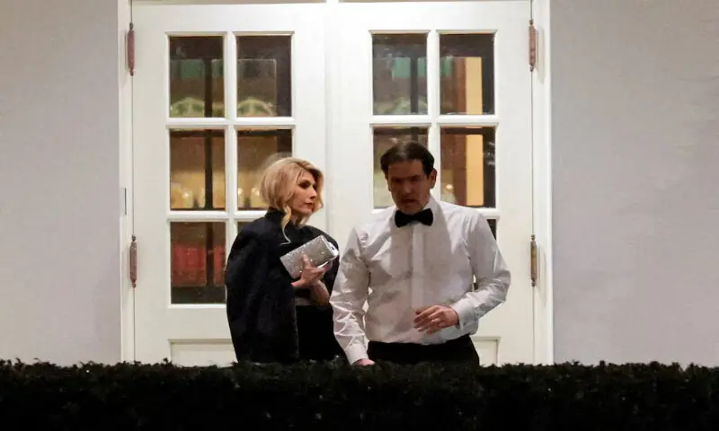 US Secretary of State Marco Rubio and his wife Jeanette Dousdebes Rubio wait at one of the West Wing entrances to be let in after US President Donald Trump returned to the White House in Washington, DC. -- Reuters