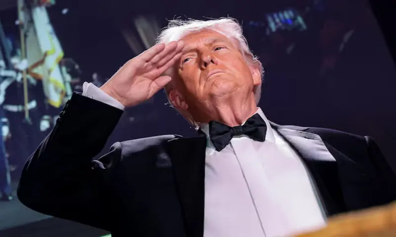 US President Donald Trump salutes during the annual White House Correspondents' Association dinner in Washington, DC. -- Reuters