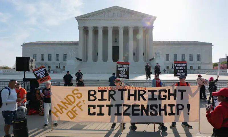 Demonstrators hold signs outside the US Supreme Court building in Washington, DC. -- Reuters