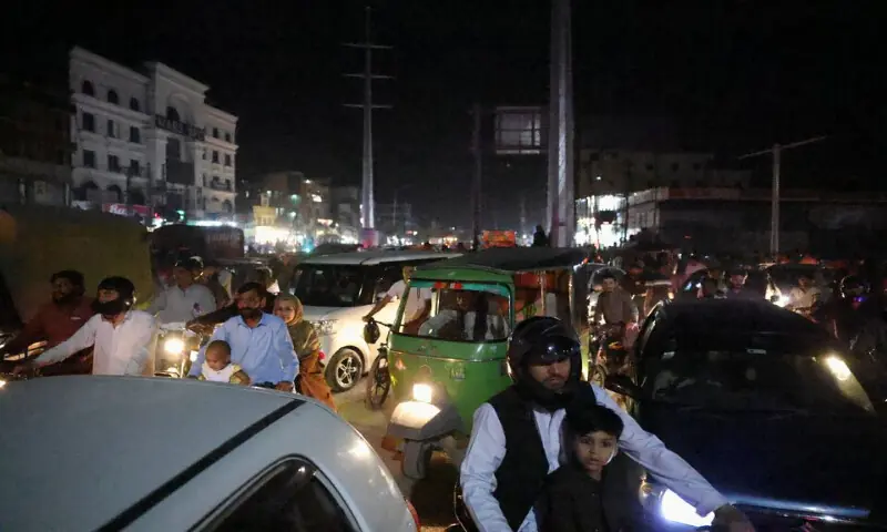 People wait as roads are blocked for a motorcade believed to be carrying Iranian Foreign Minister Abbas Araghchi to drive through in Islamabad. -- Reuters