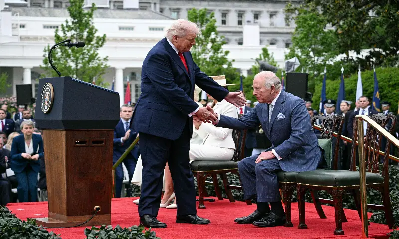 US President Donald Trump shakes hands with Britain's King Charles III during an arrival ceremony on the South Lawn of the White House in Washington, DC, on April 28, 2026. AFP