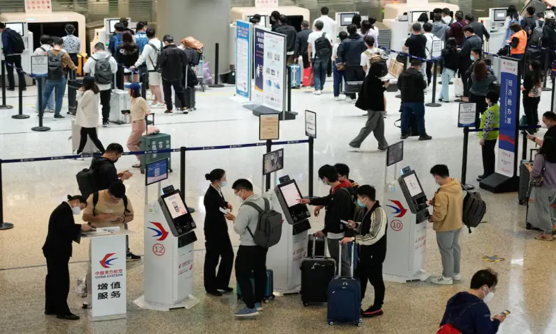 Travellers wait at check-in counters of Shanghai Hongqiao International Airport ahead of the five-day Labour Day holiday, in Shanghai, China. -- Reuters