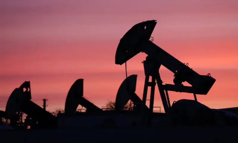 Sunset clouds glow over pump jacks at the Airankol oil field in the Atyrau region, Kazakhstan. -- Reuters