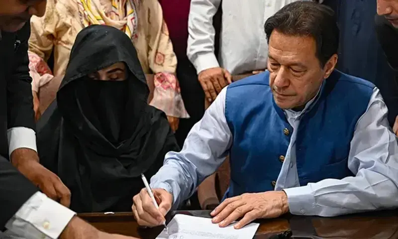 Former prime minister Imran Khan along with his wife Bushra Bibi at the registrar's office in the Lahore High court on July 17, 2023 &mdash; AFP file