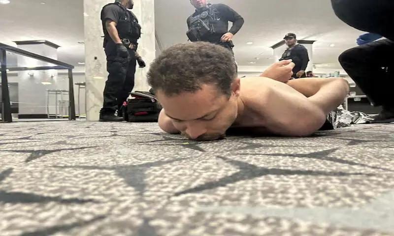 Law enforcement personnel detain Cole Tomas Allen in Washington, DC. -- Reuters