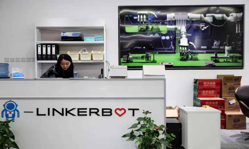A woman works at the reception desk at the office of Linkerbot in Beijing, China. -- Reuters