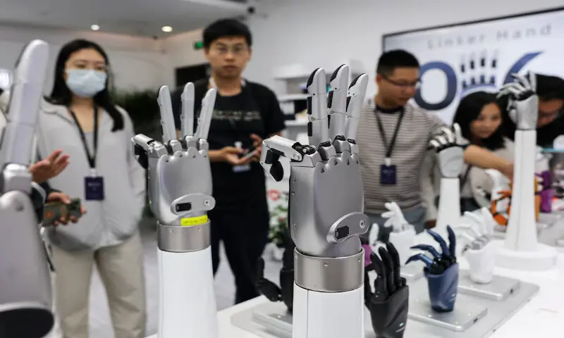 A group of visitors look at robotic hands displayed at the demonstration area of Linkerbot&rsquo;s office, in Beijing, China. -- Reuters