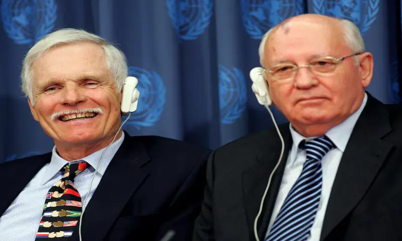 Ted Turner smiles as former Soviet President Mikhail Gorbachev speaks at a news conference in New York. -- Reuters