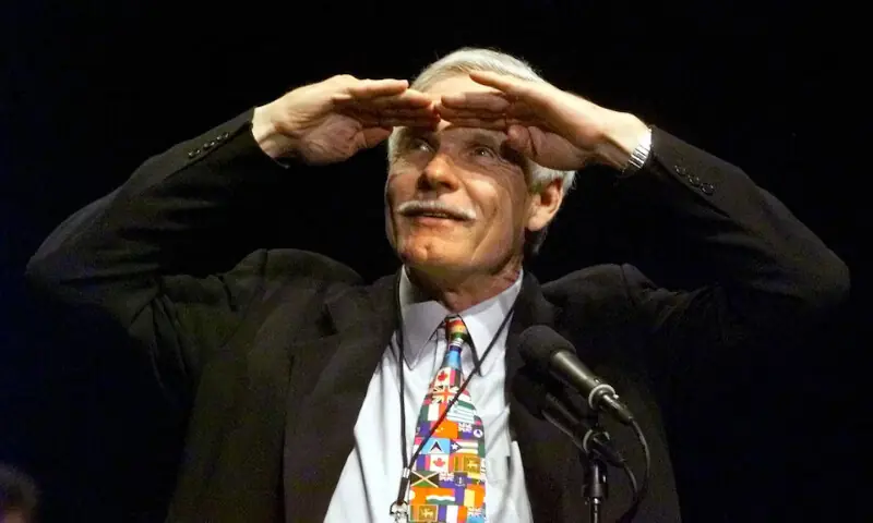 Ted Turner shades his eyes as he looks over the crowd during a standing ovation before giving an address at a CNN 20th anniversary gala event at Philips Arena in Atlanta on June 1, 2000. -- Reuters