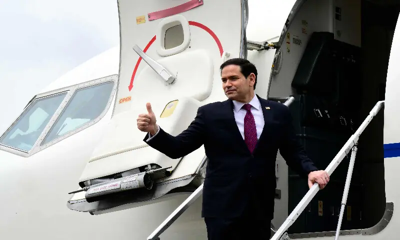 US Secretary of State Marco Rubio waves as he boards his plane at the end of a visit to Italy and the Vatican, at Rome's Ciampino airport on May 8, 2026. AFP