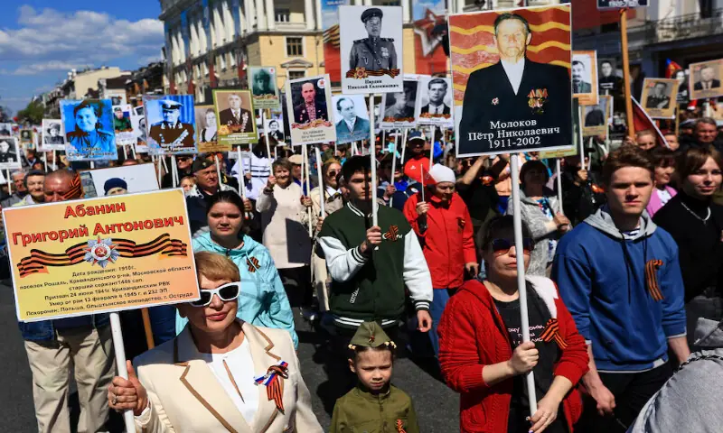Participants carry portraits of people, including Red Army soldiers and veterans, during the Immortal Regiment march on Victory Day in Vladivostok, Russia, on Saturday. -- Reuters