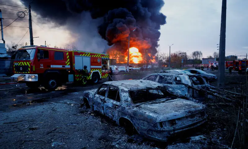 Firefighters work next to destroyed vehicles at the site of a Russian missile strike in Kyiv, Ukraine. -- Reuters