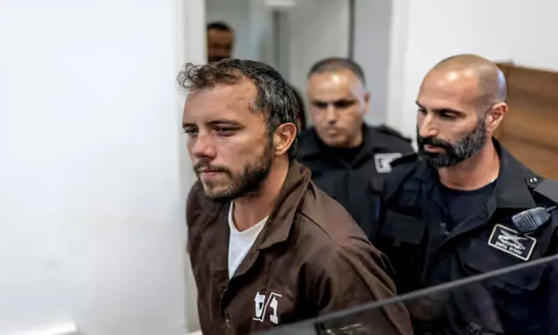 Brazil's activist Thiago Avila is escorted into court in the Israeli coastal city of Ashkelon. -- Image courtesy X