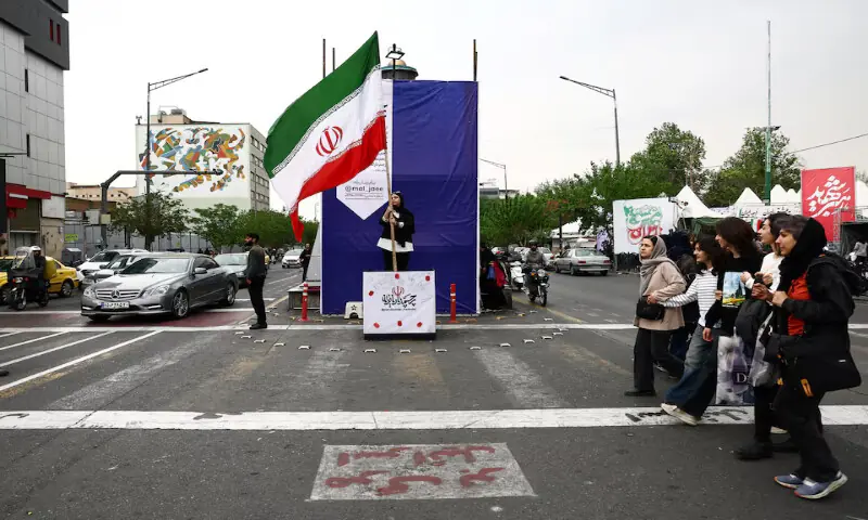 A woman holds an Iranian flag on a street in Tehran, Iran. -- Reuters