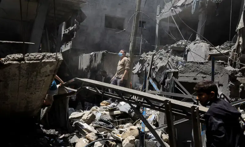 Palestinians inspect the site of an Israeli air strike on houses at Shati refugee camp in Gaza City. -- Reuters