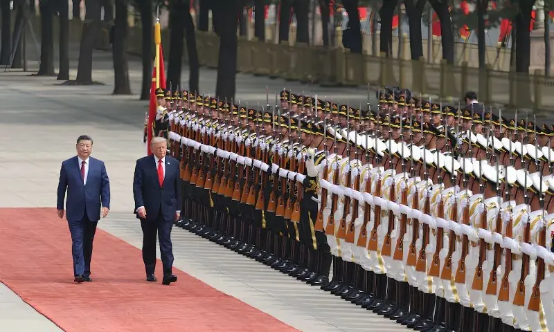 Chinese President Xi Jinping and US President Donald Trump inspect an honour guard during a welcome ceremony at the Great Hall of the People, in Beijing, China, on Thursday. -- Reuters