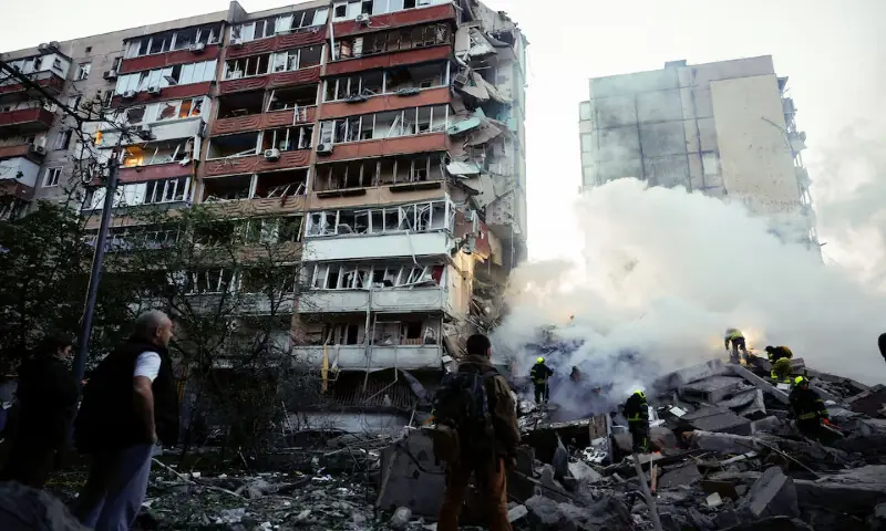 Residents look on as rescuers work at the site of an apartment building damaged during Russian missile and drone strikes, amid Russia's attack on Ukraine, in Kyiv, Ukraine, on May 14, 2026. Reuters
