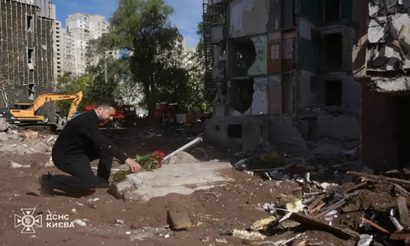 Ukraine's President Volodymyr Zelenskiy pays tribute to victims, who were killed in an apartment building damaged during yesterday's Russian missile and drone strike, amid Russia's attack on Ukraine, in Kyiv. -- Reuters