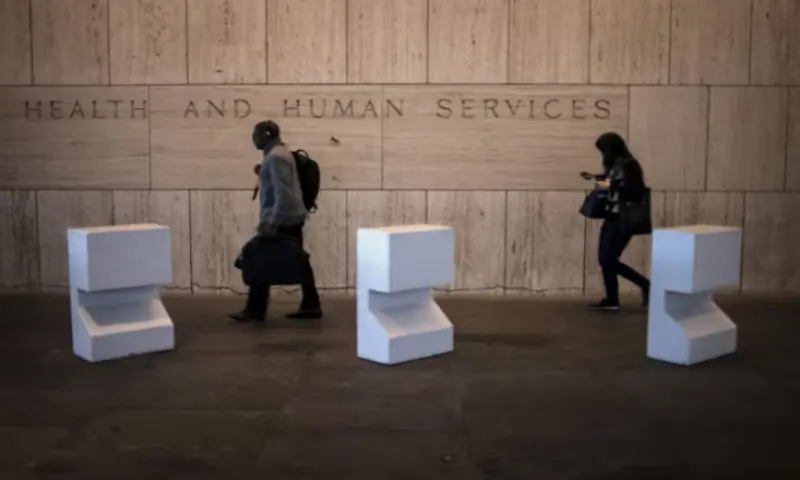 Workers arrive at the Department of Health and Human Services in Washington. -- Reuters