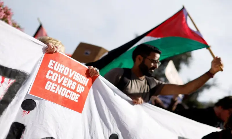 A pro-Palestinian protester holds a poster against the Eurovision Song Contest because of Israel's participation, in Sliema, Malta. -- Reuters