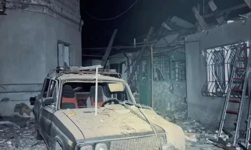 A destroyed car and damaged buildings at the site of a Russian drone strike, amid Russia's attack on Ukraine, in a location given as Odesa, Ukraine. -- Reuters