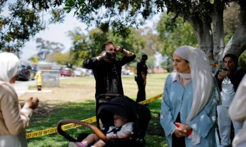 Members of the Muslim community use their phones at the scene of an active shooter situation at the Islamic Centre in San Diego, California, US. -- Reuters Members of the Muslim community use their phones at the scene of an active shooter situation at the Islamic Centre in San Diego, California, US. -- Reuters