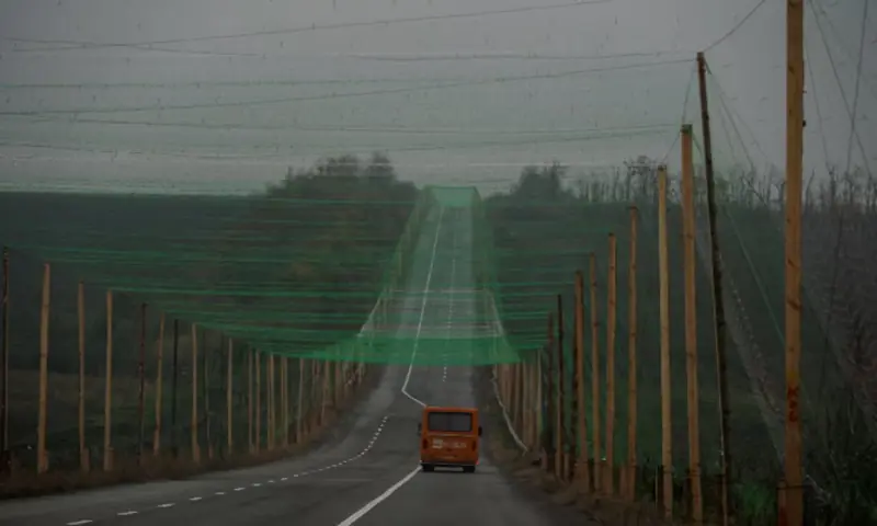 A car drives along a road covered with an anti-drone net, amid Russia's attack on Ukraine, near the town of Sloviansk in Donetsk region, Ukraine. -- Reuters