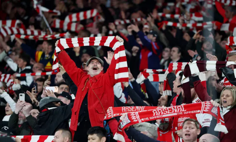 Arsenal fans celebrate after the match against Burnley in London. -- Reuters