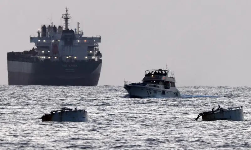 Israeli soldiers are seen on a vessel bearing symbols of the Global Sumud Flotilla, with a cargo ship behind it, as seen from Ashdod, southern Israel. -- Reuters Israeli soldiers are seen on a vessel bearing symbols of the Global Sumud Flotilla, with a cargo ship behind it, as seen from Ashdod, southern Israel. -- Reuters