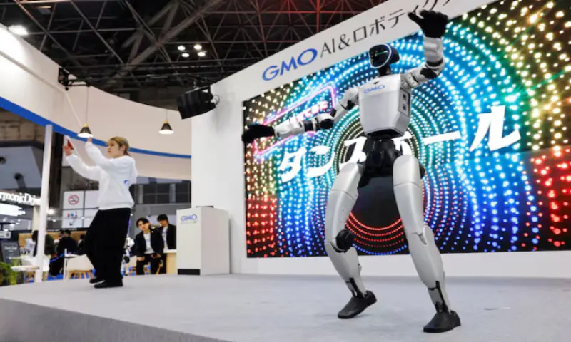 GMO AI and Robotics' humanoid robot Unitree G1 dances alongside a dancer to the music at GMO's booth in the International Robot Exhibition 2025 at Tokyo Big Sight in Tokyo, Japan. -- Reuters