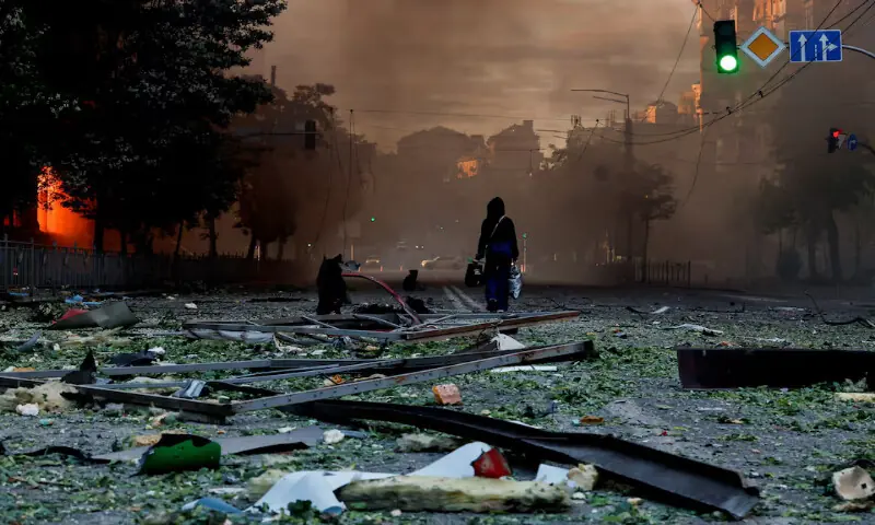 A person walks on a debris-scattered street in the aftermath of an overnight Russian missile and drone strike in Kyiv, Ukraine. -- Reuters