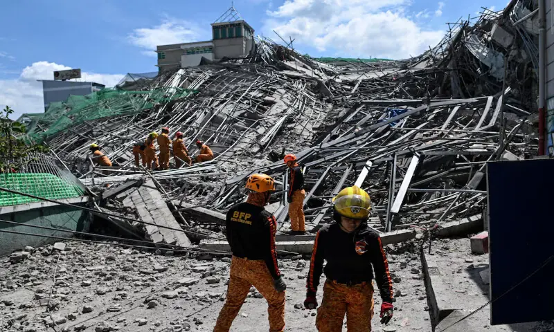 Rescue workers search for survivors among debris as an under construction nine-storey building collapsed in Balibago, Angeles City, Pampanga, Philippines, on Sunday. --- Reuters