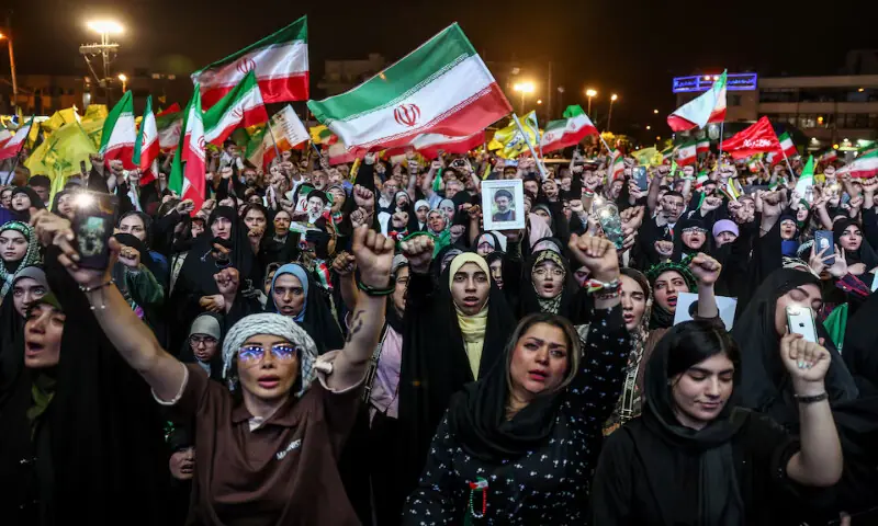 People chant slogans during a rally in Tehran, Iran. -- Reuters