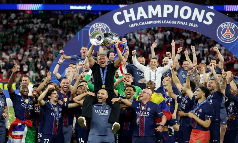 Paris St Germain coach Luis Enrique with the trophy celebrates with players and staff after winning the UEFA Champions League. -- Reuters Paris St Germain coach Luis Enrique with the trophy celebrates with players and staff after winning the UEFA Champions League. -- Reuters